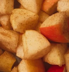 apples and potatoes are piled up in a pile on top of each other with brown speckles