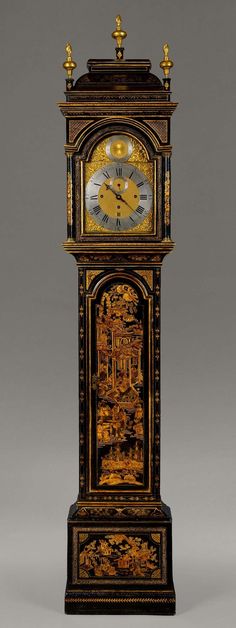 an ornate clock with gold and black decorations