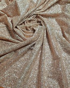 a close up view of a shiny fabric with small glitters on the top and bottom