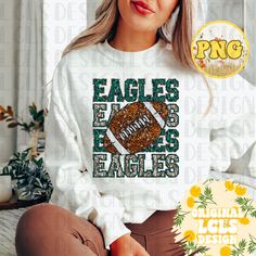 a woman sitting on the floor wearing an eagles sweatshirt