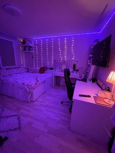 a bedroom with purple lights and a bed