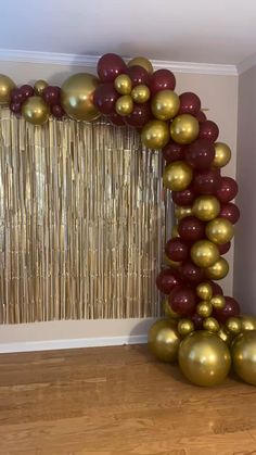 gold and burgundy balloon arch with metallic balloons