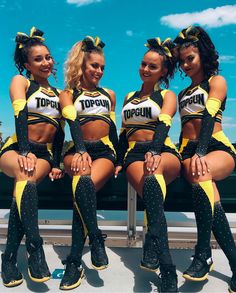 three cheerleaders are posing for the camera