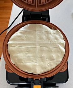 a pancake being made in a waffle iron on top of a countertop