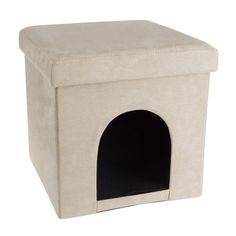 a white dog house with a black cat in it's door and the top open