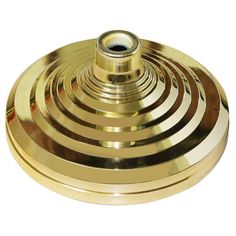 a golden metal object with four circles on the bottom and one circle in the middle