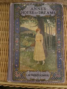 an old book is on display in a wicker basket with the title'anne's house of dreams '