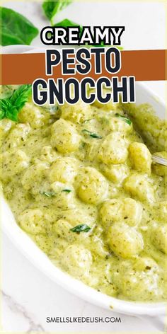 creamy pesto gnocchini in a white bowl with basil garnish