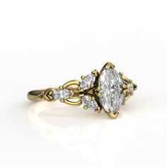 a yellow gold engagement ring with three pear shaped diamonds on the sides and an oval center stone