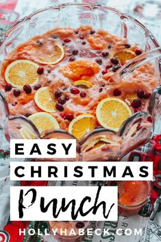 an easy christmas punch recipe with oranges and cranberries in a glass dish