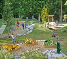 children are playing in the garden with rocks and flowers