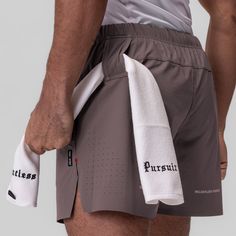 Durable training shorts in a refined aesthetic. Distinguished by laser perforated branding across the front and ventilation holes on the back. The shell is constructed from a technical ripstop material with four-way stretch. An internal brief liner provides support and moisture control. Internal drawstrings and a channeled waistband add an adjustable fit. Storage includes a hidden right-side zip pocket, a left-side open pocket, and a utility loop for a shirt or towel. Side splits with reinforced Soft Techwear, Pockets Fashion Details, Activewear Details, Sportswear Details, Technical Apparel, Vintage Shirt Design, Athleisure Men, Adaptive Clothing, Technical Clothing