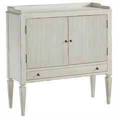 a white cabinet with two doors and drawers