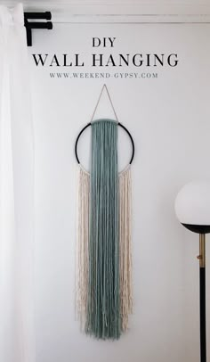 the diy wall hanging is made with macrame yarn and tassels