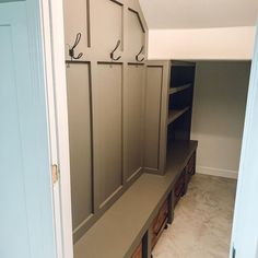 an empty room with some wooden benches and shelves