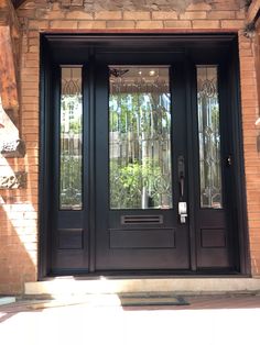 a black front door with glass panels and sidelights