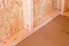 the corner of a room that is being built with plywood boards and wood veneers