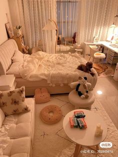 a dog sitting on top of a bed in a bedroom next to a table and chairs