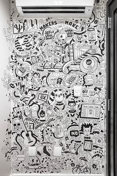 a bathroom with black and white doodles on the wall next to an air conditioner