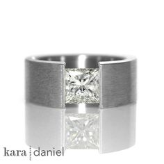 a white gold ring with a princess cut diamond