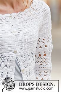 a woman is wearing a white crochet top and has her hands in her pockets