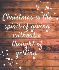 the words christmas is the spirit of giving without a thought of getting written on wood