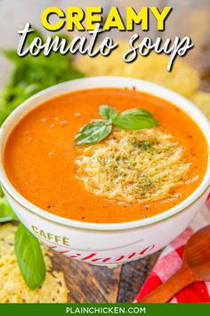 creamy tomato soup in a white bowl with basil garnish