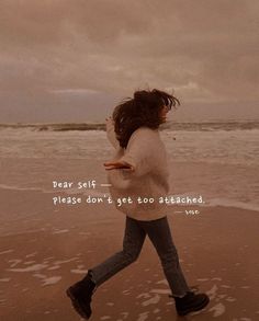 a girl running on the beach with her hair in the wind and an inspirational quote