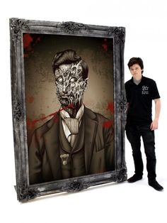 a man standing in front of a painting with a skull on it's face