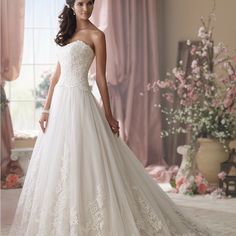 a woman in a white wedding dress posing for the camera