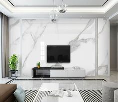 a modern living room with white marble walls and flooring, large tv on the wall