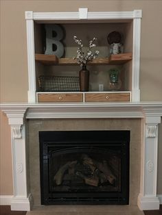 a fireplace with shelves above it and a fire place in the middle that has flowers on top