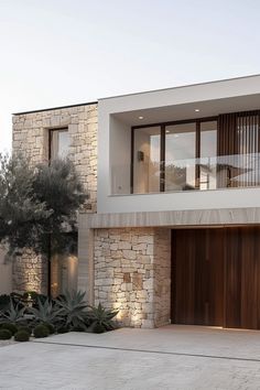 a modern house with stone and wood exterior