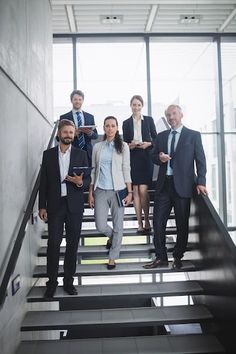 a group of business people walking up some stairs