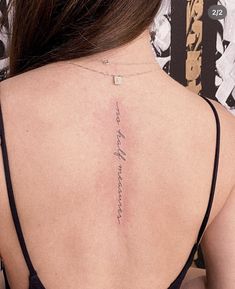 the back of a woman's neck with writing on her left shoulder and lower back