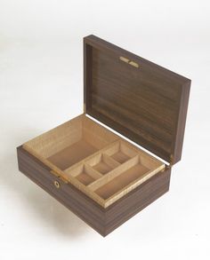 an open wooden box with compartments on the inside