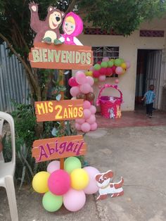 a bunch of balloons that are in front of a sign with some animals on it