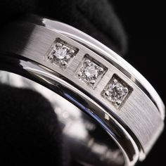 a wedding ring with three diamonds on it