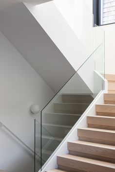 a staircase with glass railing and wooden steps