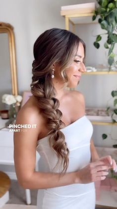 a beautiful woman in a white dress holding flowers