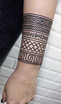 a person with a black and white tattoo on their arm