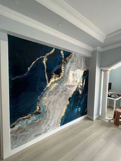 a living room with a large painting on the wall next to a table and chairs