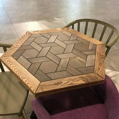 a wooden table sitting on top of a purple chair