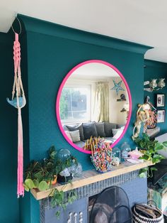 a living room filled with furniture and a large round mirror on the wall above a fire place