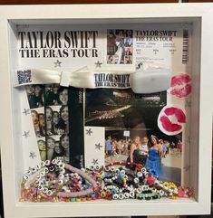 a white frame with some pictures and beads on the front, along with other items