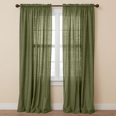 a green curtain hanging in front of a window