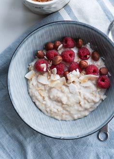 a bowl of oatmeal with raspberries and almonds