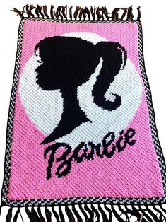 a pink and black blanket with a silhouette of a woman's head on it