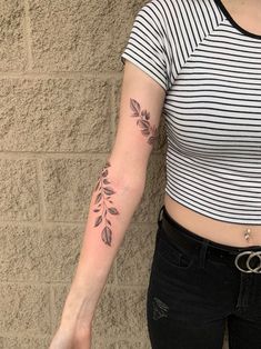 a woman with a flower tattoo on her arm