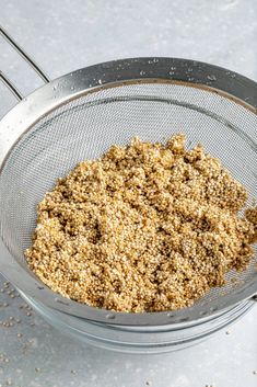 a metal strainer filled with food on top of a table